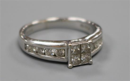 A modern 18ct white gold and princess cut diamond cluster ring with diamond set shoulders, size K.